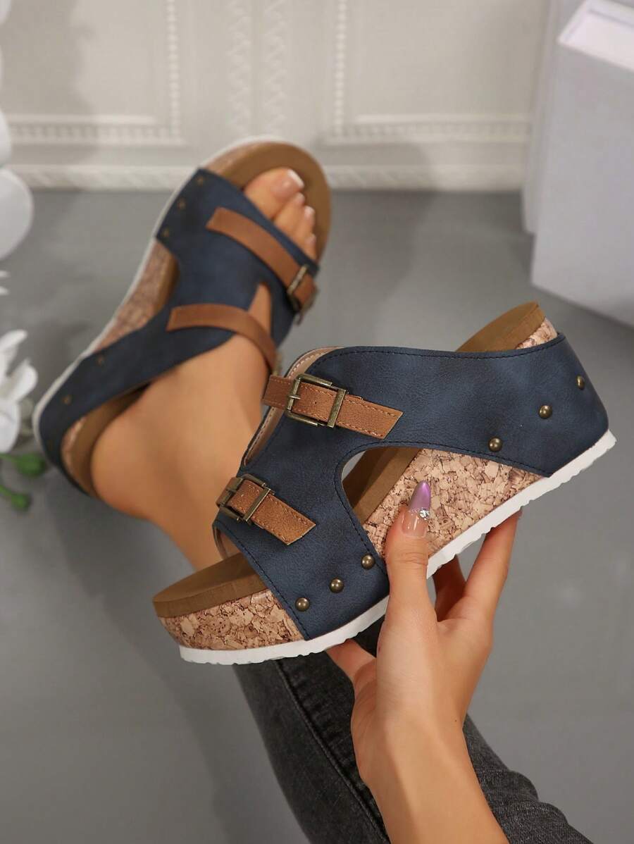 Step into summer with these playful plus size wedge heel sandals! Featuring double buckle straps and eye-catching rivet details, they add a bold twist to warm-weather outfits. Comfortable yet stylish, the wedge heel gives you a lift while keeping you grounded for all-day fun. Perfect for sunny strolls, beach days, or casual gatherings where you want to stand out with effortless charm.