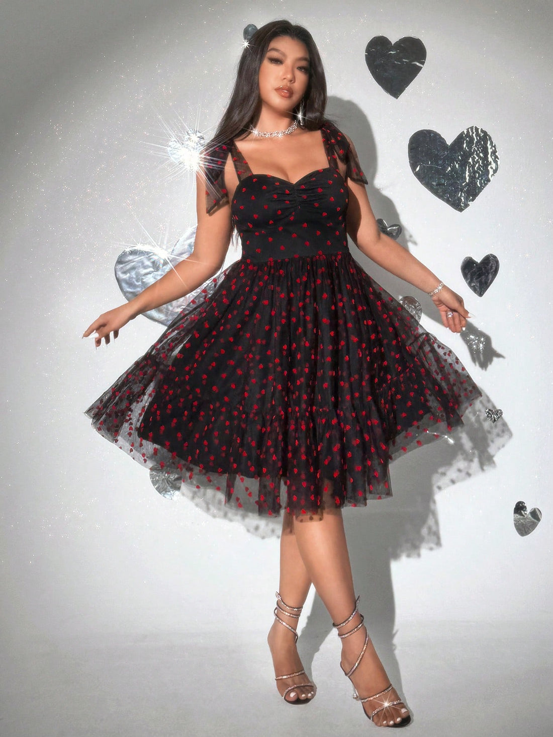 Celebrate love in style with this Plus Size Valentine's Day Heart Bow Tulle Flocked Dress. Featuring a charming heart pattern and a playful bow detail, its soft tulle fabric adds a flirty, romantic touch. Designed to flatter and feel comfortable, this dress is perfect for making your Valentine’s Day unforgettable.