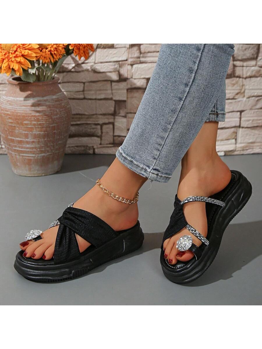 Side view of black jeweled platform slides with chunky molded sole
