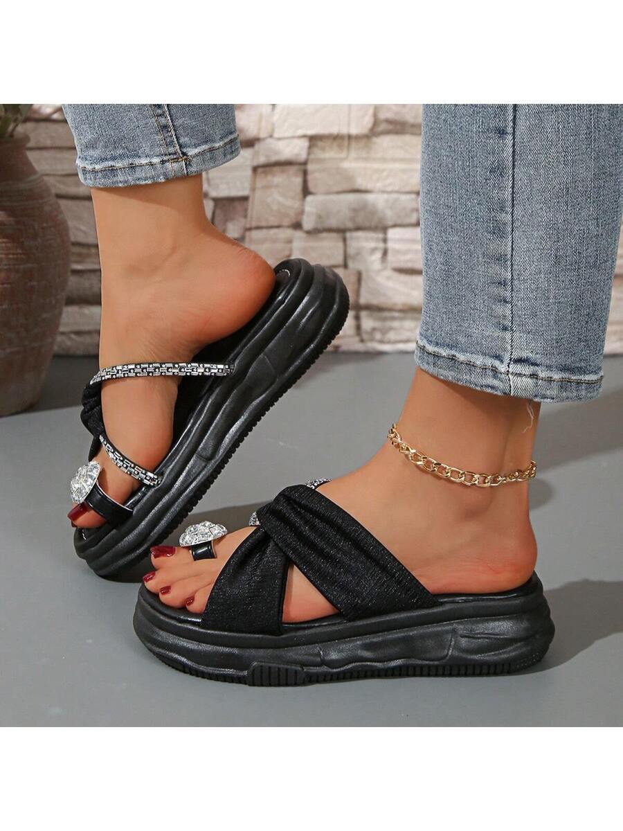 Top view of black open toe rhinestone sandals with clear round toe jewel