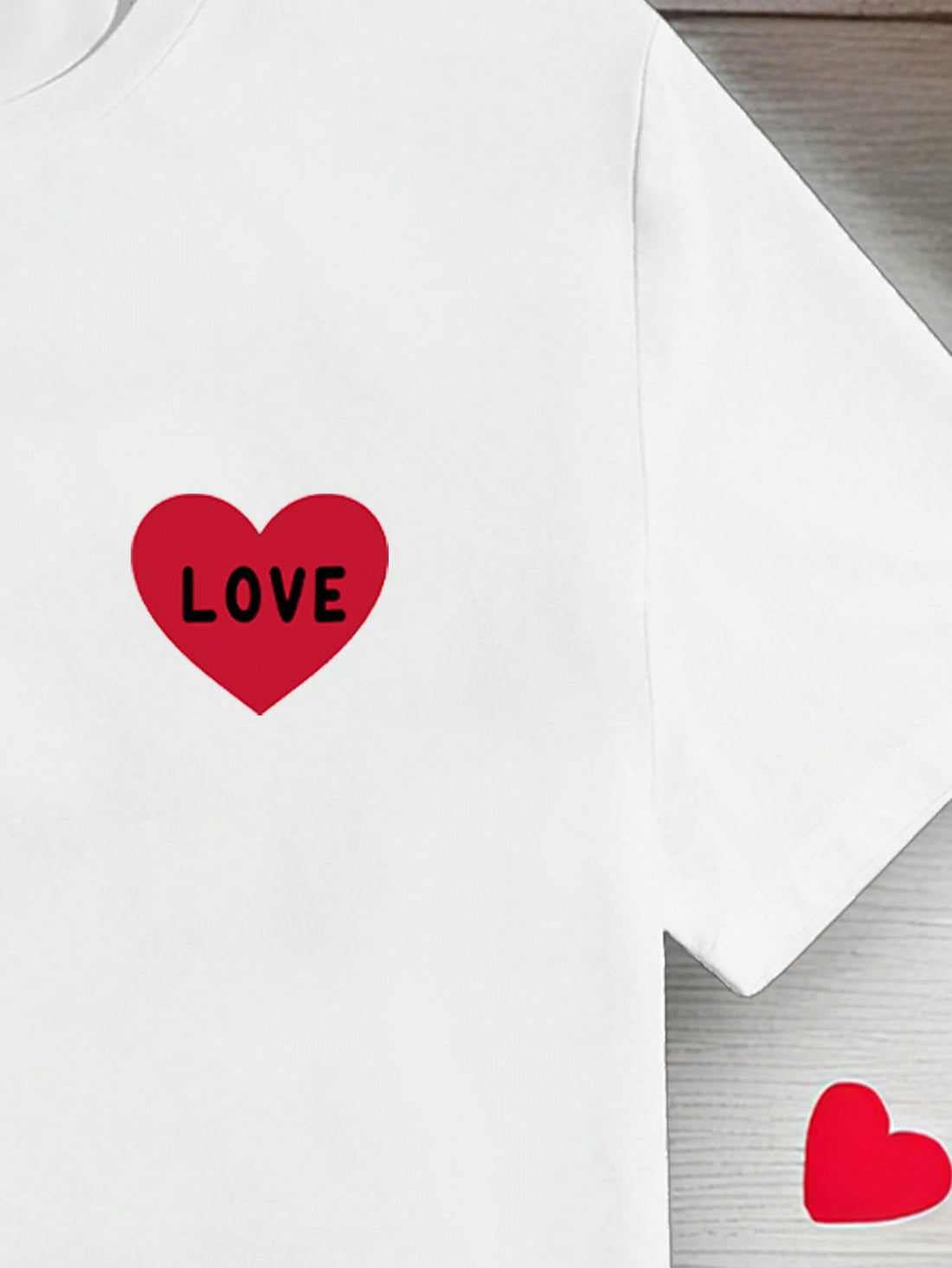Show your love in a fun and casual way with our Heartfelt Style T-Shirt! Featuring a playful heart letter print, this shirt is perfect for Valentine's Day or any day you want to spread some love. Made with high-quality materials, it's both stylish and comfortable.