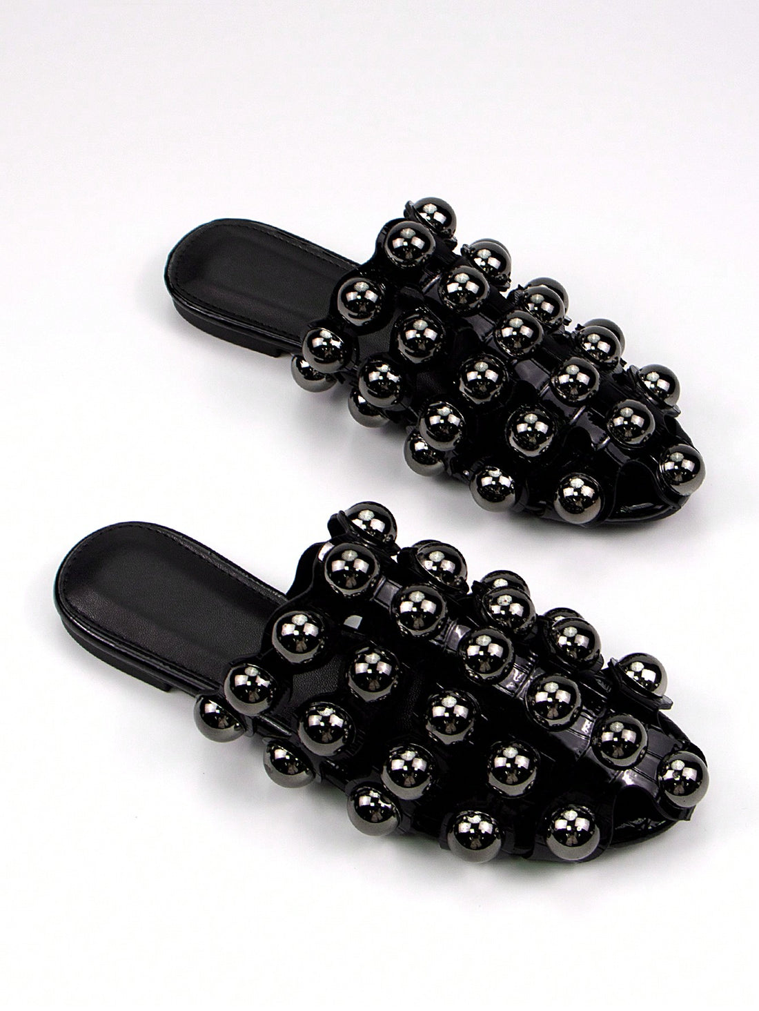 Step out in style with these chic black glossy crocodile slip-on mules, designed to turn heads this fall and winter. The sleek crocodile texture adds a touch of bold elegance, while metal rivet details bring a playful edge. Easy to slip on, they blend comfort with standout fashion, perfect for elevating any seasonal outfit with a bit of attitude.