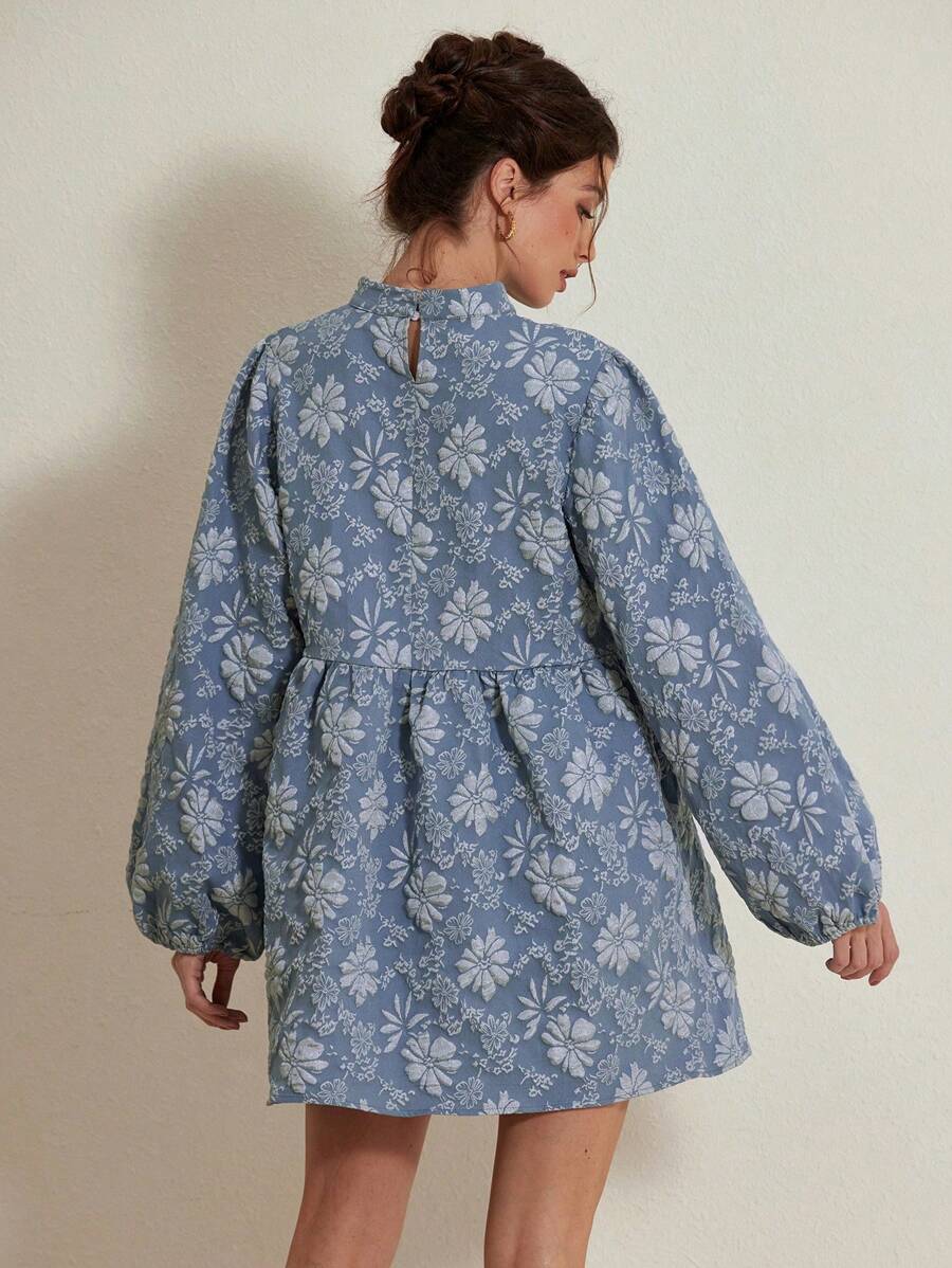 Step into seasonal style with this exquisite floral mini dress. The elegant A-line cut and voluminous lantern sleeves deliver sophisticated charm perfect for autumn gatherings. Its all-over botanical print in deep blue tones brings visual depth, while the high-waist silhouette provides a flattering fit. Built from 100% polyester woven fabric with a refined stand collar and button accents, this piece transitions effortlessly between casual brunches and evening events. The gracefully flared hem creates moveme