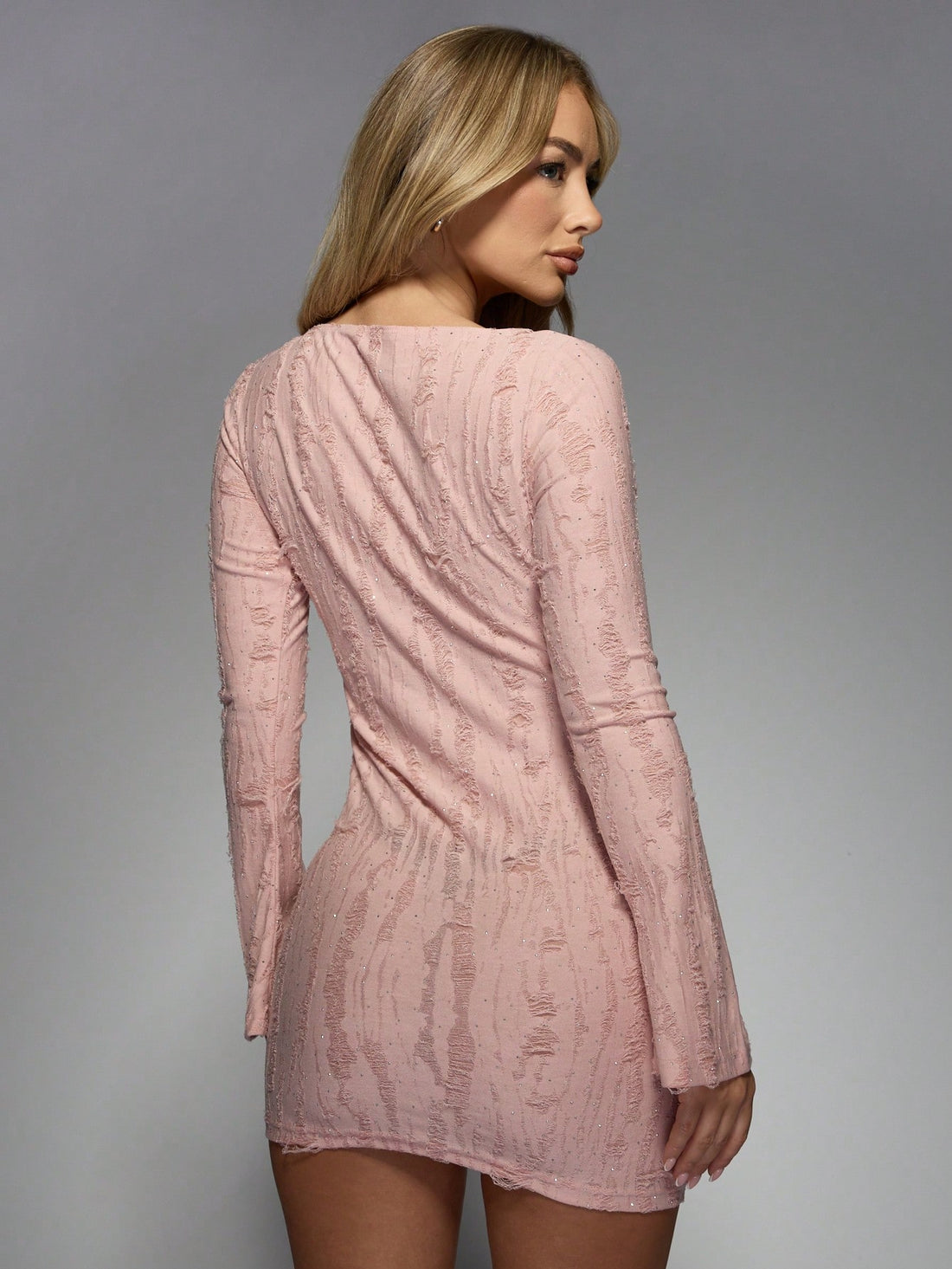 Get ready to turn heads with our Chic Textured Distressed Flare Long Sleeve Bodycon Mini Dress! This dress effortlessly combines style and comfort with its chic textured design and flared silhouette. Perfect for any occasion, this dress will elevate your look with minimal effort. Say goodbye to boring outfits and hello to effortless style!