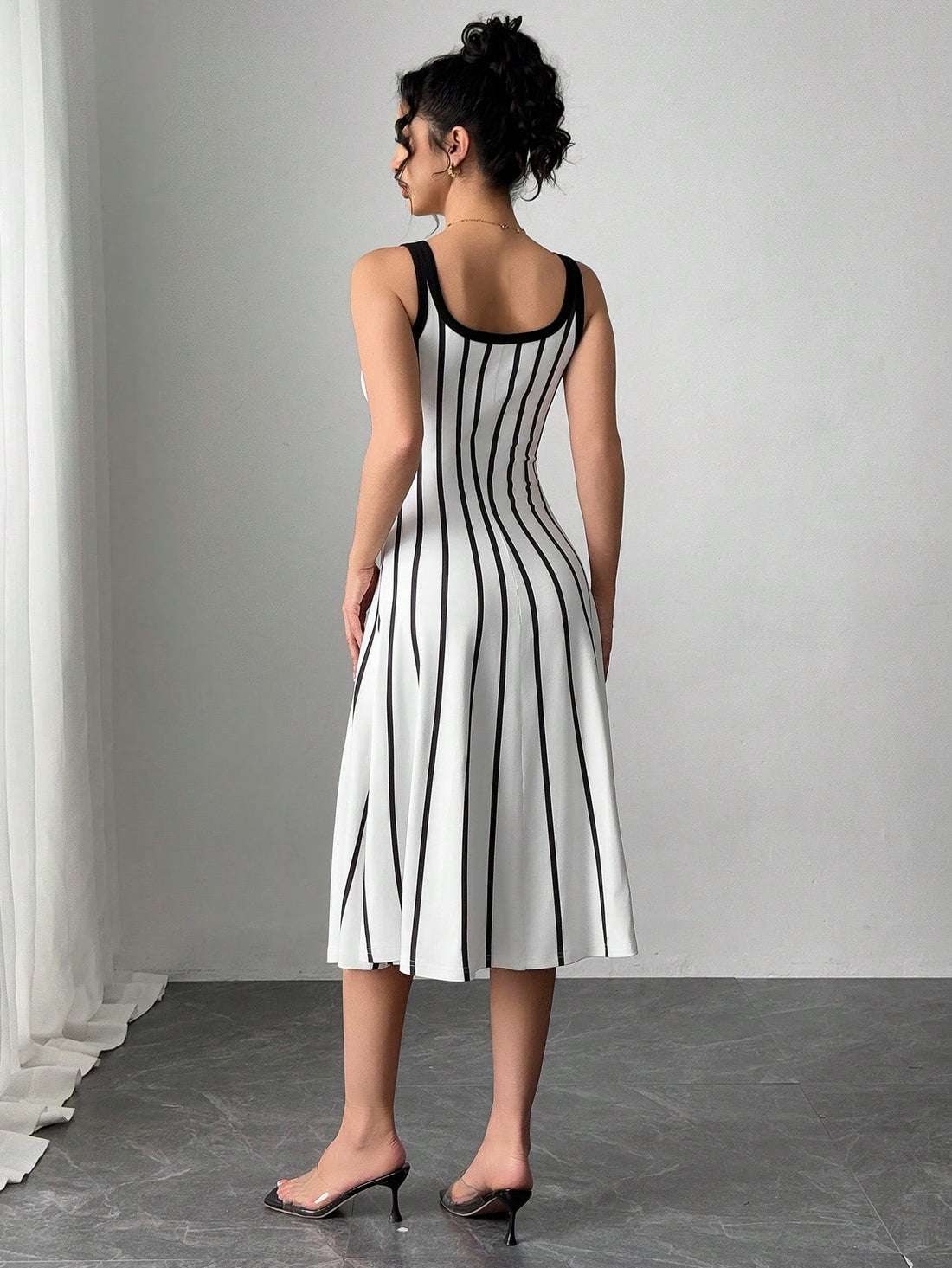Get ready to turn heads with this effortlessly chic black and white striped dress! The loose-fit design and wide straps make it comfortable to wear all day long, while still looking stylish. Perfect for any occasion, this dress is a must-have for your wardrobe.