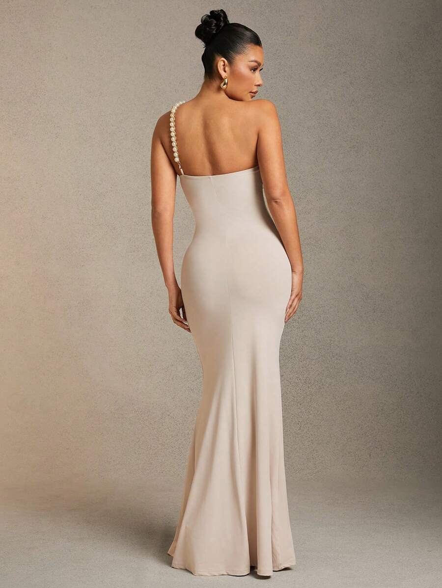Make a splash at your next event in this show-stopping mermaid dress! Featuring an eye-catching faux pearl bustier that catches the light beautifully, this gown hugs your curves in all the right places before flowing into a dramatic fishtail hem. Perfect for galas, proms, or any occasion where you want to turn heads and feel absolutely fabulous. The elegant silhouette flatters your figure while the shimmering pearl details add that extra touch of glamour. Dive into sophistication and let your inner mermaid 