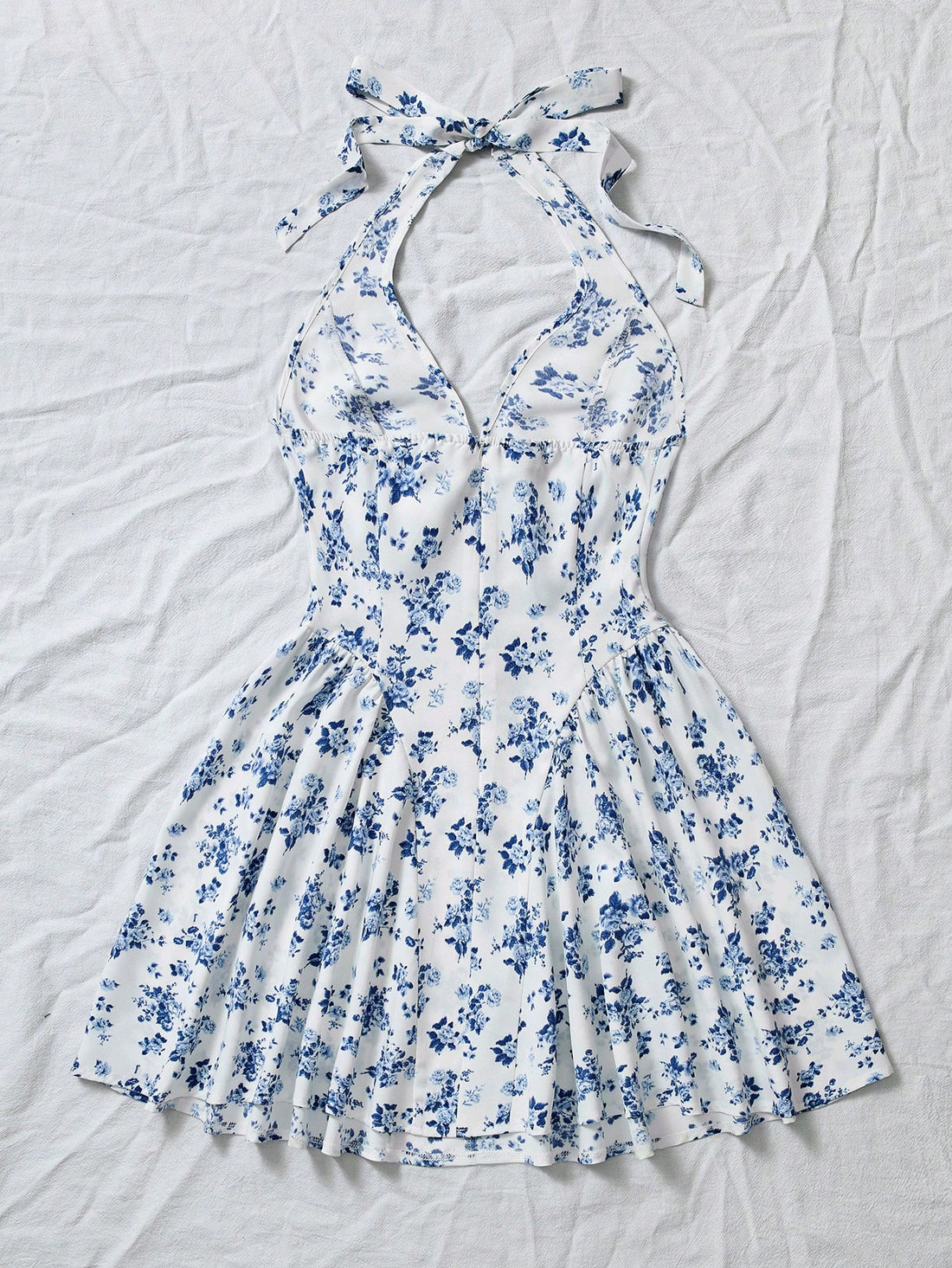 Be bold and flirty in this Blue Ditsy Floral V-Neck Backless Peplum Short Dress! Show off your feminine side with a charming floral print, plunging v-neck, and playful peplum skirt. The backless design adds a touch of sass to this already stunning dress. Perfect for a night out or special occasion.