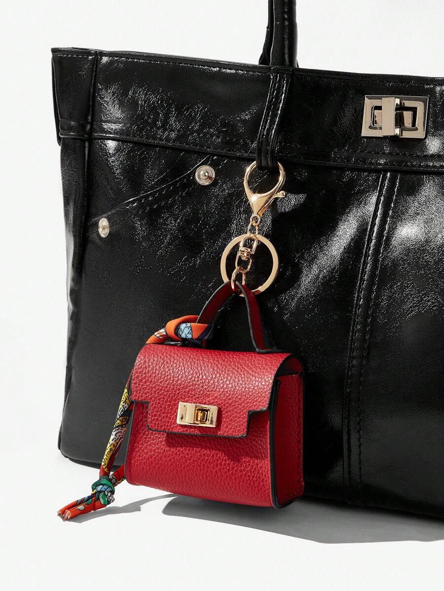 Close-up view of mini key ring holder keychain coin purse earphone pouch bag charm with chain strap, coin purse format, key ring detail for small-item storage
