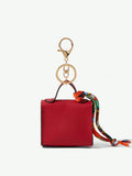 Close-up view of mini key ring holder keychain coin purse earphone pouch bag charm with chain strap, coin purse format, key ring detail for small-item storage