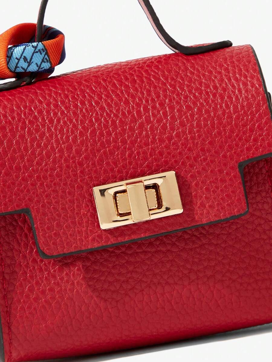 Close-up view of mini key ring holder keychain coin purse earphone pouch bag charm with chain strap, coin purse format, key ring detail for small-item storage