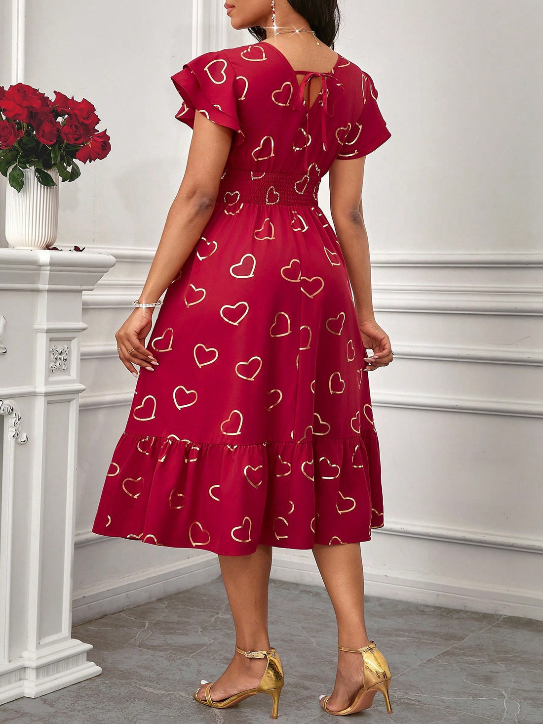 Dress to impress (your special someone) in our Elegant Red Cap Sleeve Dress with Gold Heart Accents. Perfect for Valentine's Day and any stylish occasion, this dress adds a touch of playful glamour to your wardrobe.