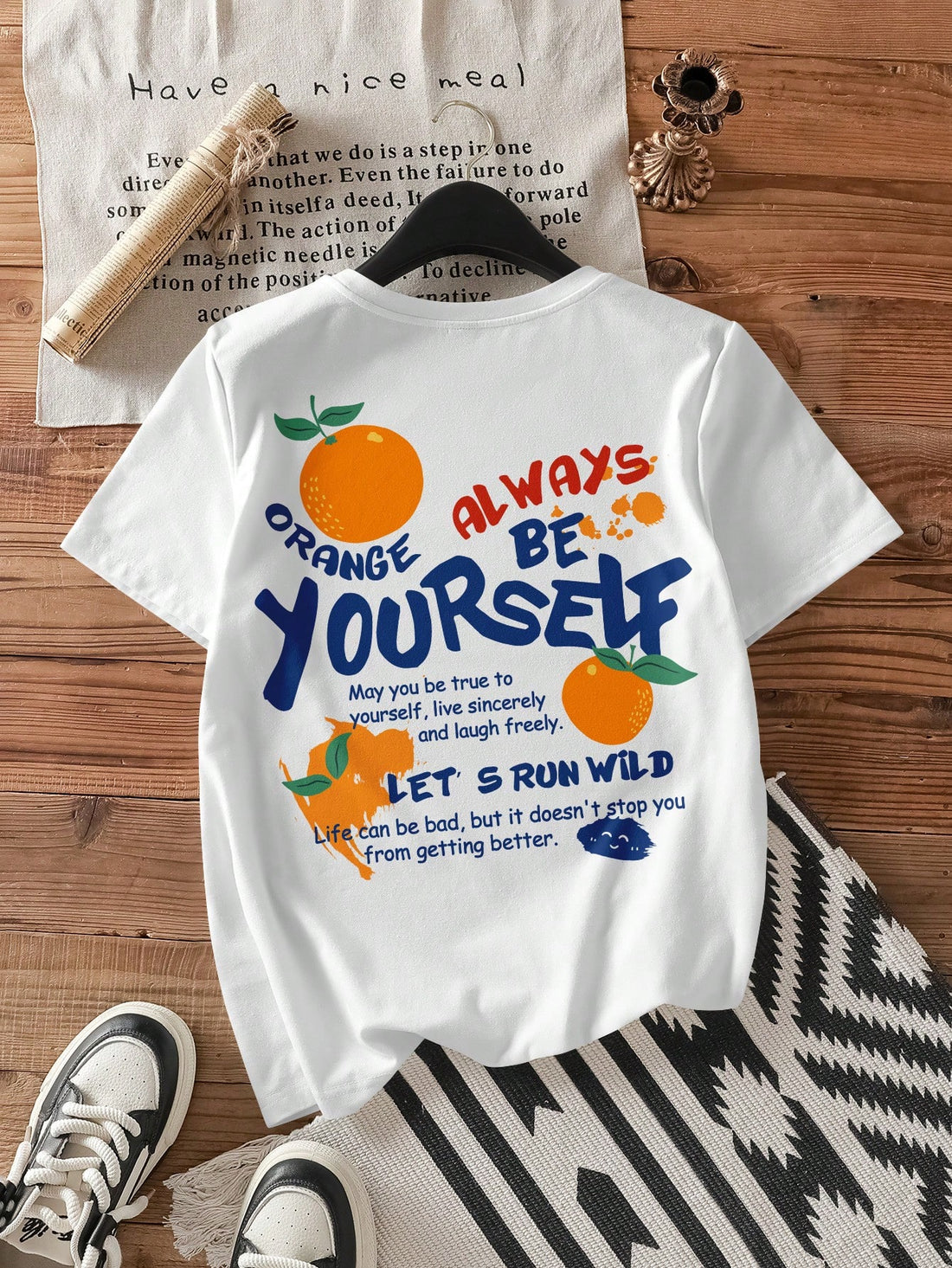 Get ready to turn heads this summer with our vibrant Orange Graffiti Graphic Tee! This playful white t-shirt features a bold, colorful design that pops against its crisp short sleeves and classic round neck. Perfect for sunny days and casual outings, it adds a fun splash of style to any outfit while keeping you cool and comfy. Embrace the season with a tee that’s as lively and bright as your summer adventures!
