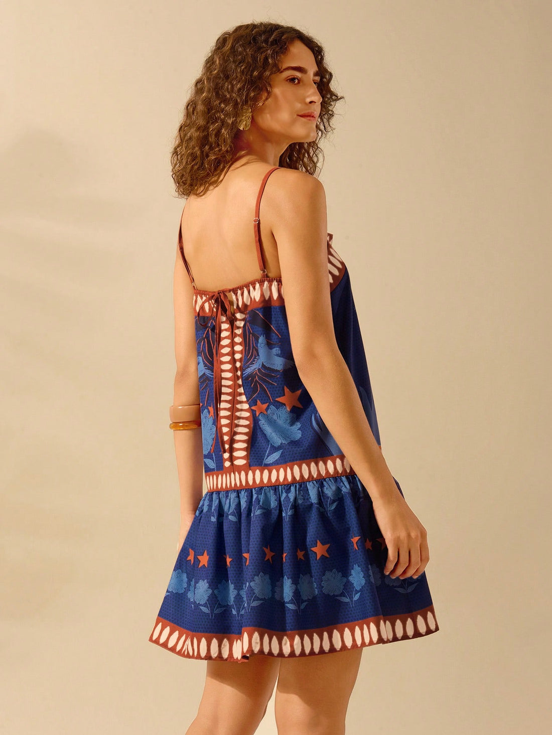 Dress to impress with our Boho Charm summer dress! With a playful star, flower, and bird print, this dress is sure to turn heads. The adjustable spaghetti straps offer a perfect fit while the lightweight fabric keeps you cool and comfortable. Bring some charm to your wardrobe today!