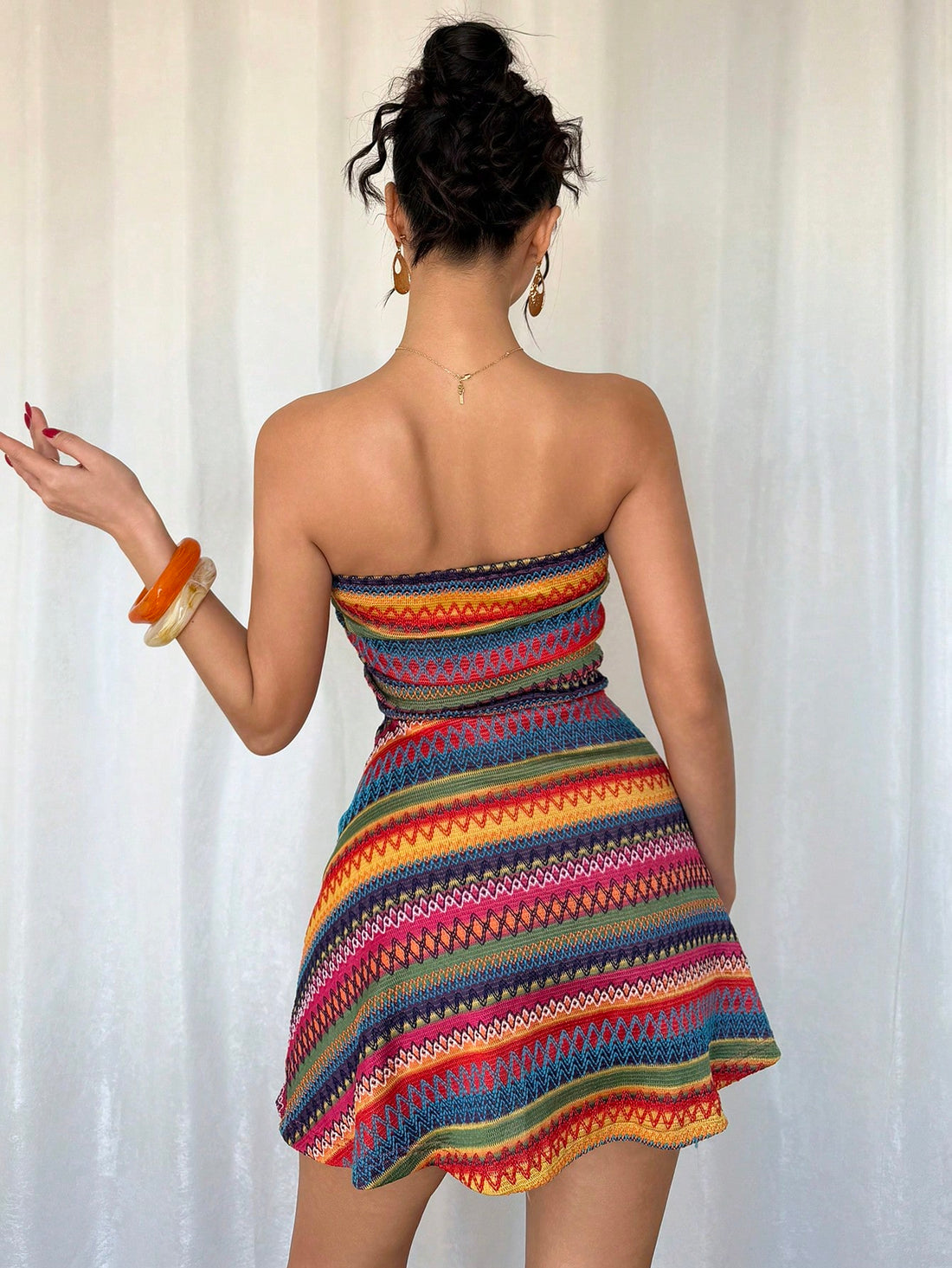 Effortlessly bring glamour to any occasion with this Iridescent Pleated Crop Top Mini Dress. The unique iridescent fabric and pleated design add playful flair to your look. Perfect for any event, let this dress be your go-to for a quirky, yet fabulous statement.