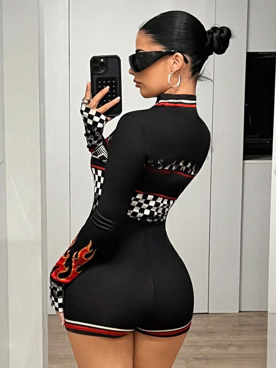 Front view of black racing graphic long-sleeve zip romper with checkerboard and flame print