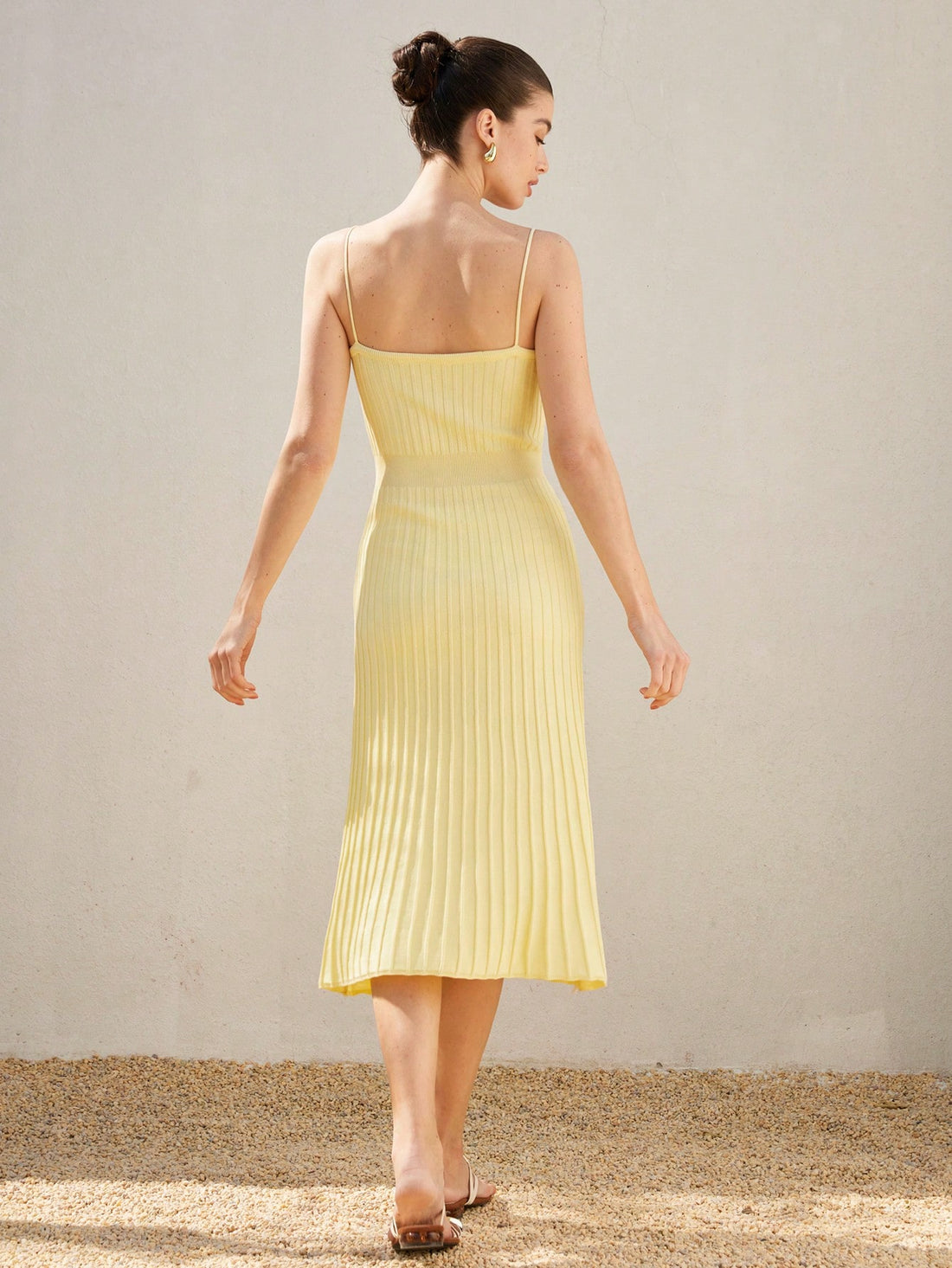 Brighten your wardrobe with this playful yellow sleeveless sweater dress. The ruched waist adds a flirty touch, while the flared hem creates a fun, flowing silhouette. Perfect for sunny days or cozy evenings, this dress combines comfort and style effortlessly.