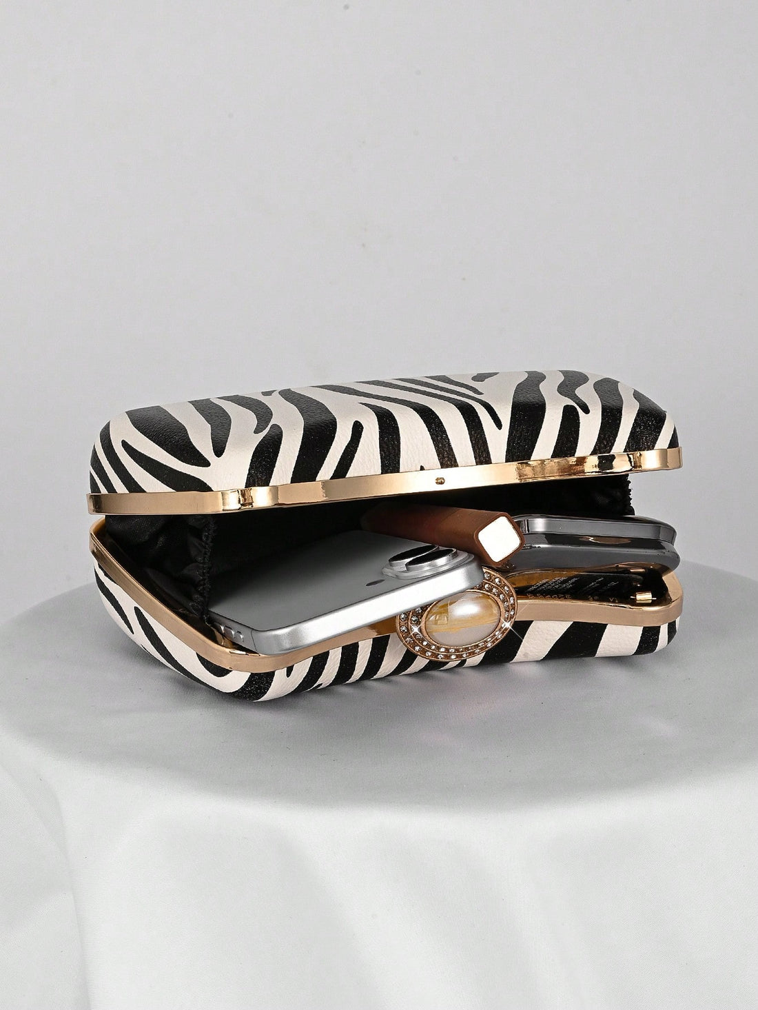 Make a bold entrance with this chic zebra print box clutch, perfect for weddings and formal events. Its striking pattern adds a playful twist to your elegant outfit, while the compact design keeps your essentials close at hand. Personalize your look and turn heads with this unique fashion statement that blends wild style with sophisticated charm.