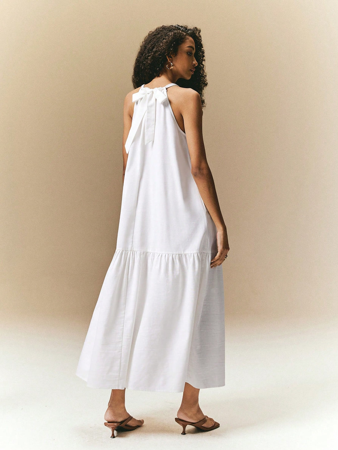 Make a chic statement effortlessly with our Halter Maxi Dress. Designed with a white ruffled hem, this dress also features convenient pockets. Enjoy comfort and style in one!