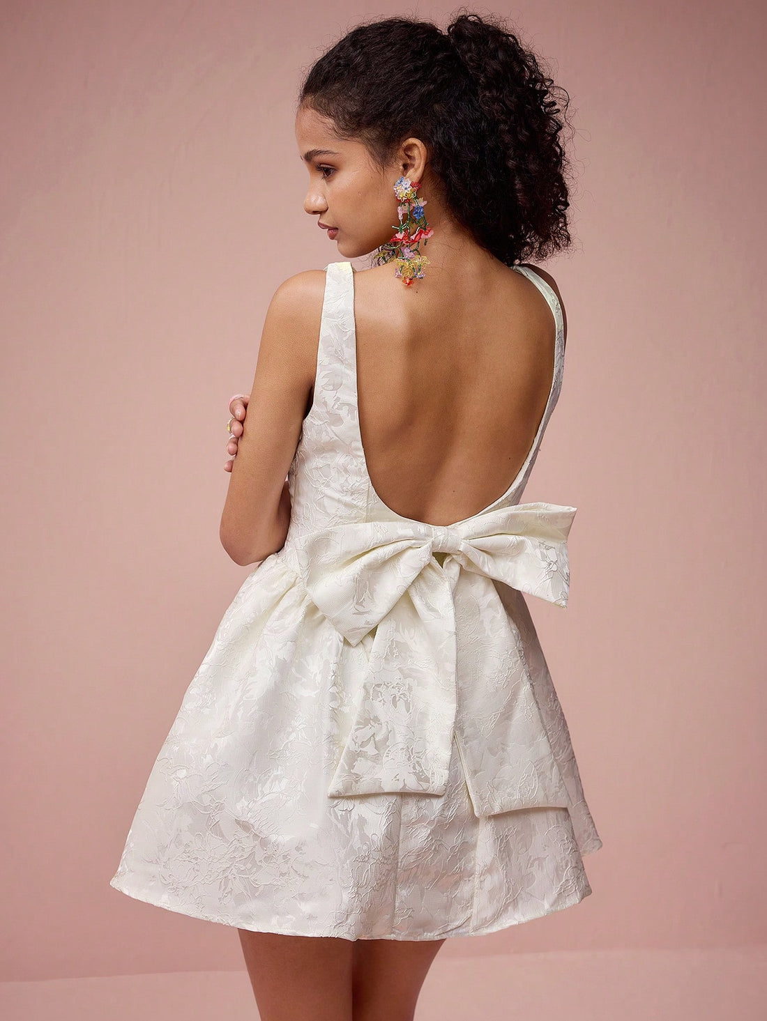 Unleash your charm and make a statement in this Charming Apricot Satin Jacquard Mini Dress. The perfect choice for romantic dates and special occasions, this dress features a big bowknot that adds a playful touch. Feel confident and fabulous in this stylish and unique dress.