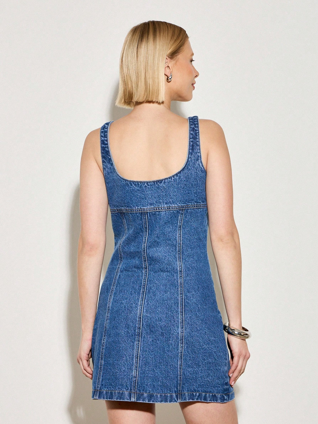 Step into summer with this playful retro-inspired mini denim dress! Featuring a charming button-front design, it effortlessly blends vintage vibes with modern flair. Perfect for sunny days and casual outings, this dress offers a flirty silhouette that’s both comfortable and stylish. Embrace easygoing chic and make every moment a little more fun in this must-have summer staple.