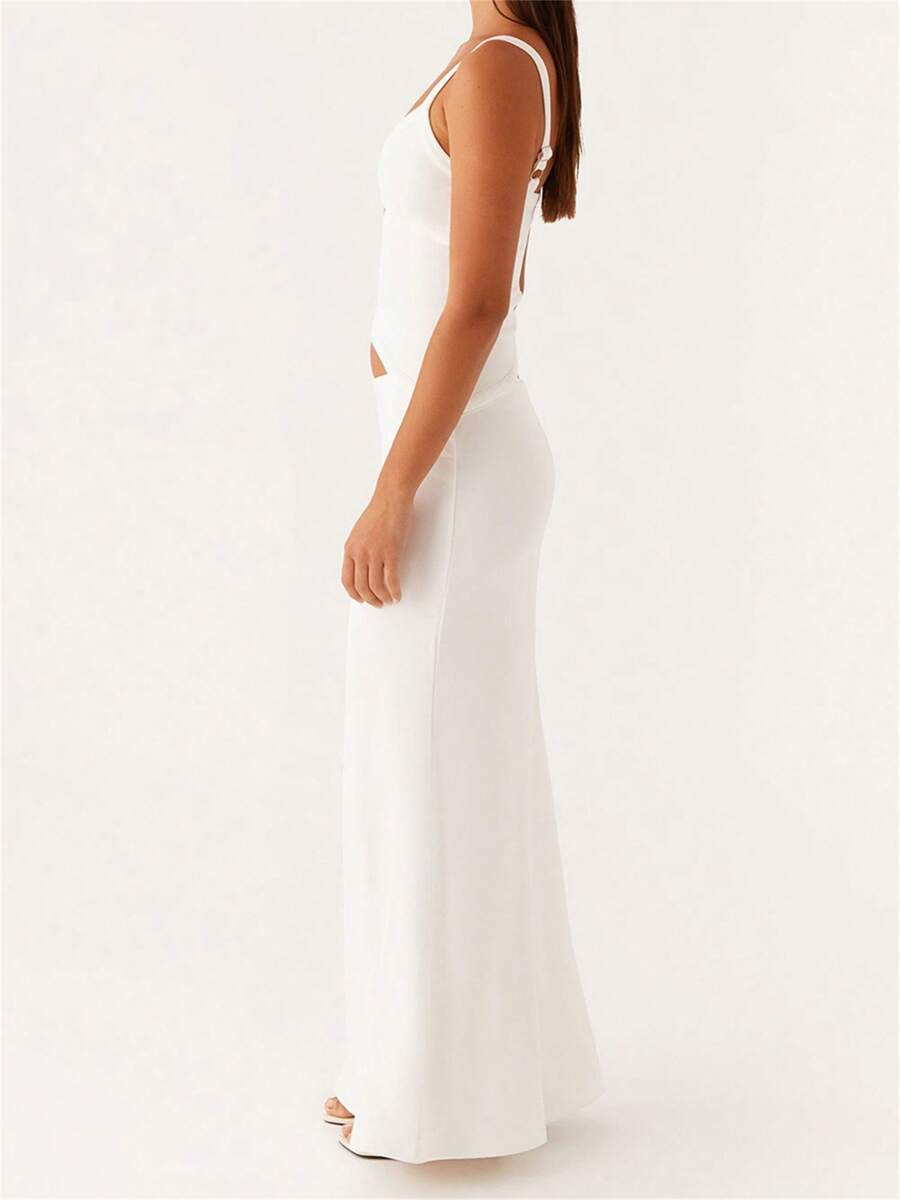 Slip into effortless elegance with this stunning bodycon maxi dress. The deep V-neck and delicate spaghetti straps create a sophisticated silhouette, while the cut-out detail adds a modern edge. Crafted from a comfortable woven blend of 95% polyester and 5% elastane, this sleeveless design flatters your figure with its regular fit and low waistline. Perfect for summer parties, weddings, date nights, and special celebrations, this versatile piece transitions seamlessly from day to evening. The plain white fa