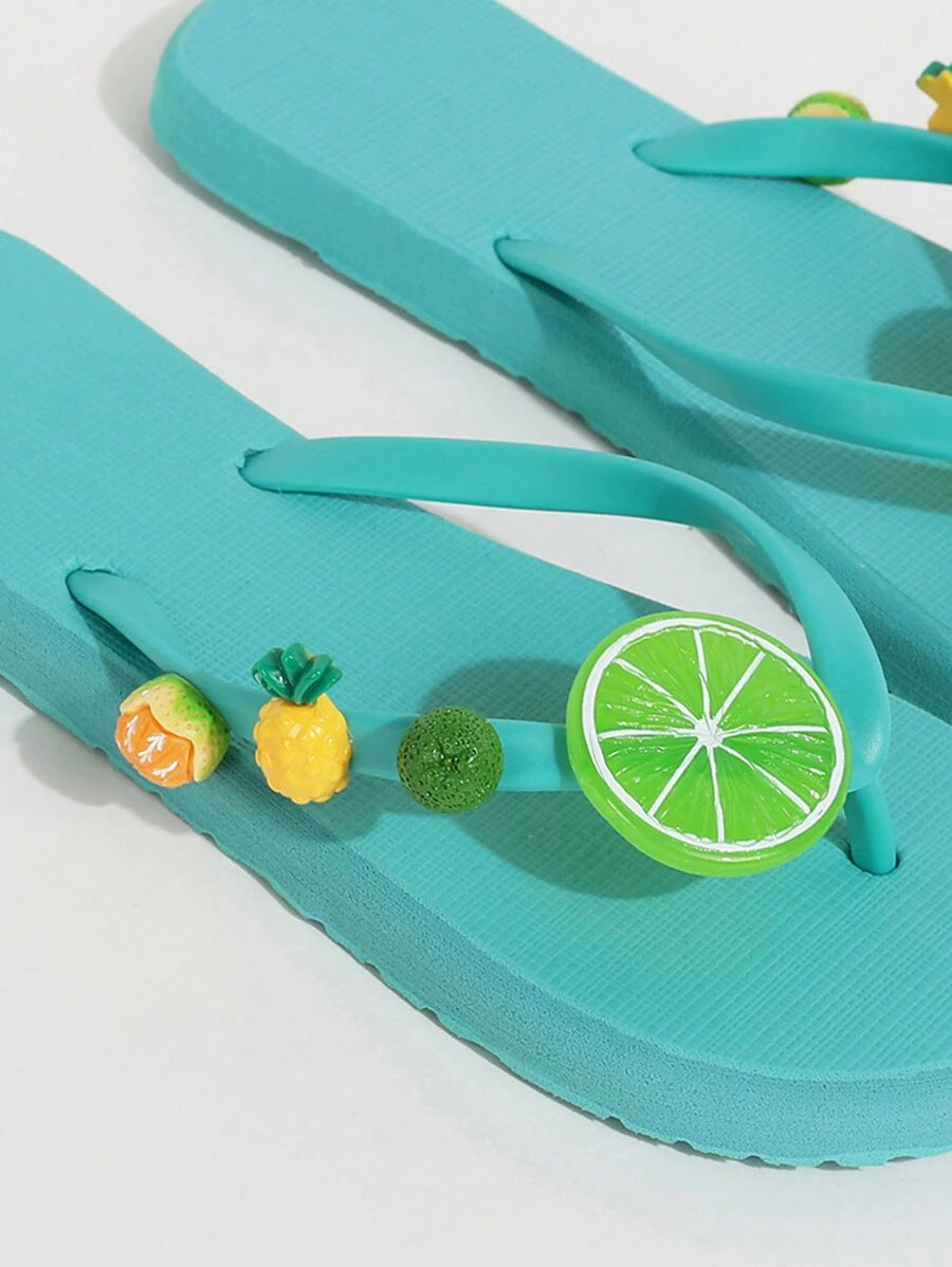 Product-only close view of blue flip-flops with lime and pineapple details