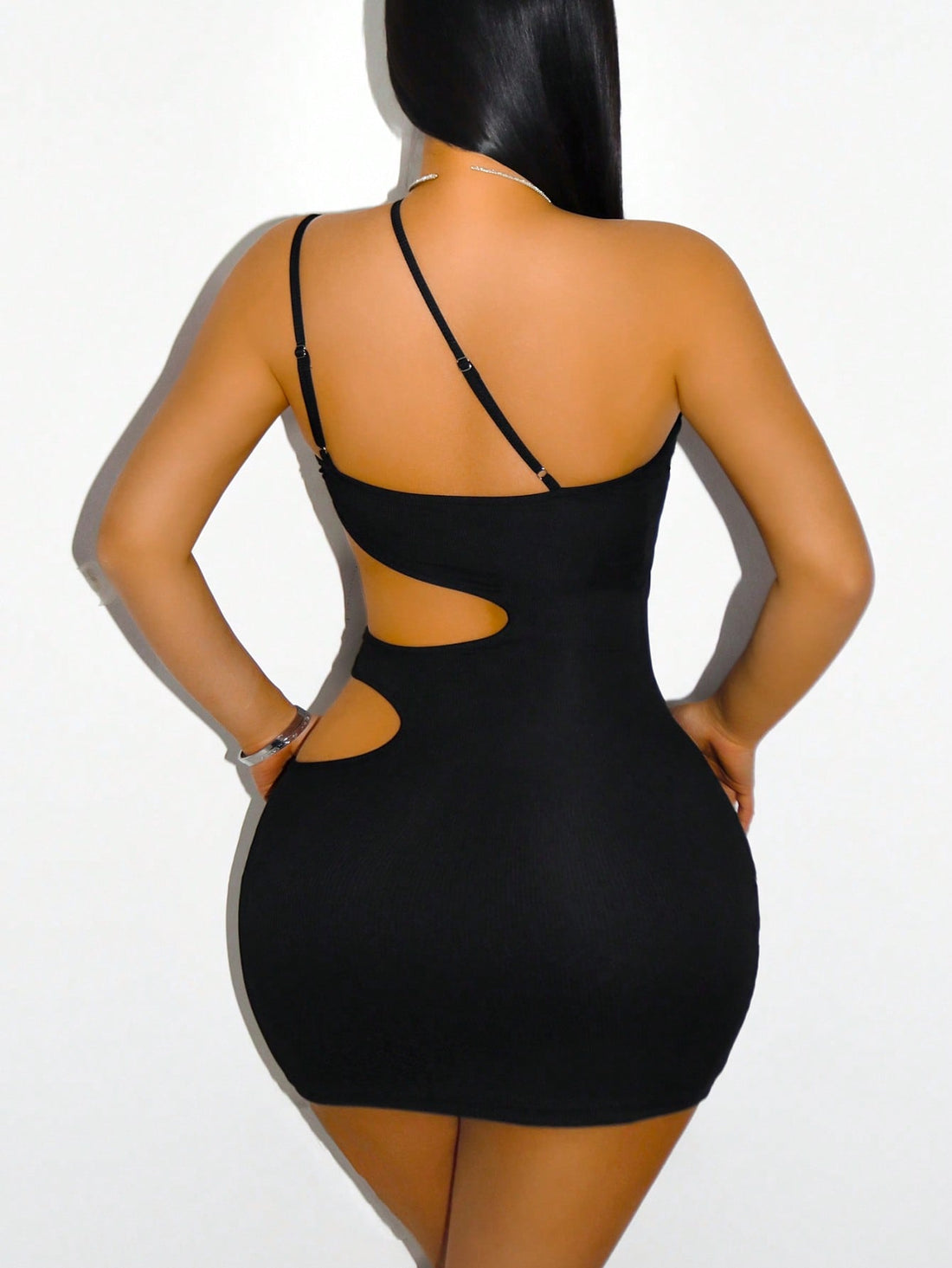 Turn heads this season in our backless cutout cami mini dress—the ultimate statement piece for sun-soaked brunches and festival adventures. Featuring a daring open back and chic cutout details, this dress combines flirty femininity with modern edge. The lightweight, breathable fabric keeps you cool and comfortable all day long, while the flattering mini silhouette shows off your best features. Whether you're sipping mimosas with friends or dancing under the stars, this versatile dress delivers effortless st