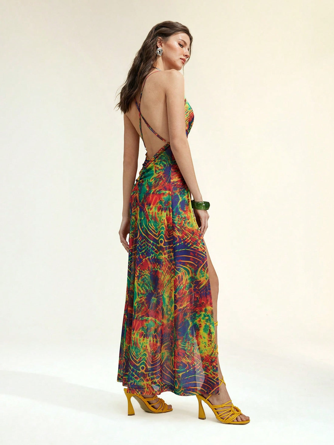 Step into summer with this playful floral print mesh maxi dress. Featuring a draped neck and a daring backless design, it’s perfect for vacation days filled with sunshine and breezy evenings. Lightweight and flowy, this dress combines elegance with comfort, making every moment feel like a stylish getaway.