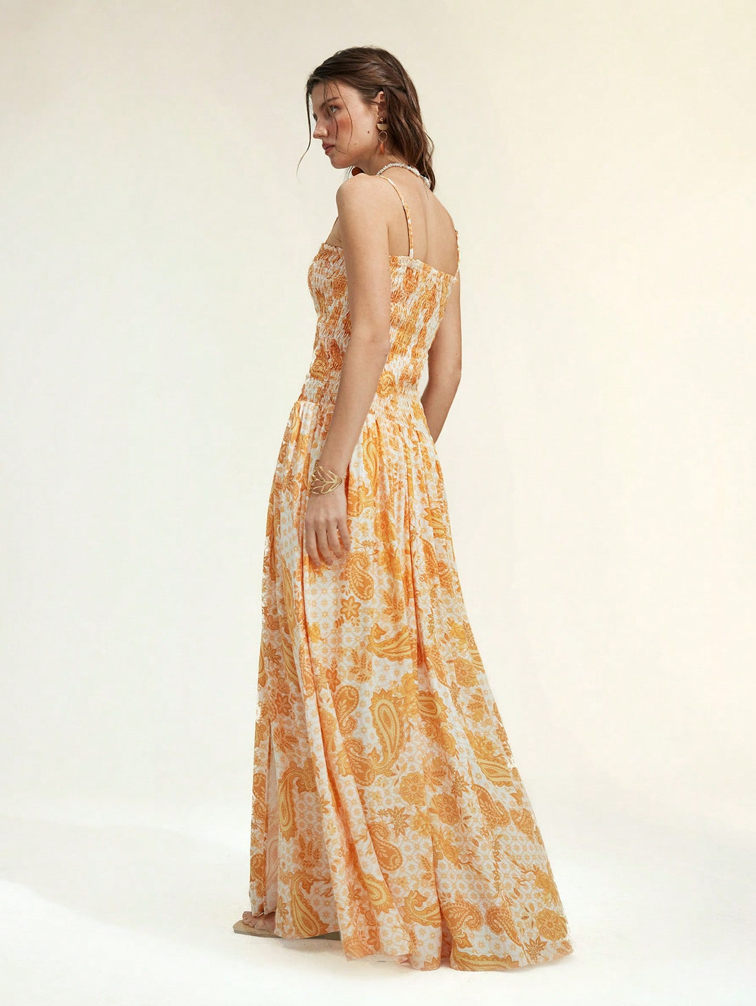 Brighten your summer getaway with this playful yellow paisley maxi dress. Featuring a flirty lace-up front and a breezy side slit, it’s designed to keep you cool and stylish under the sun. Perfect for beach strolls or sunset dinners, this dress combines comfort with a splash of vibrant charm.