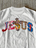 Close-up of white Jesus graphic T-shirt showing crew neckline and ornate chest artwork