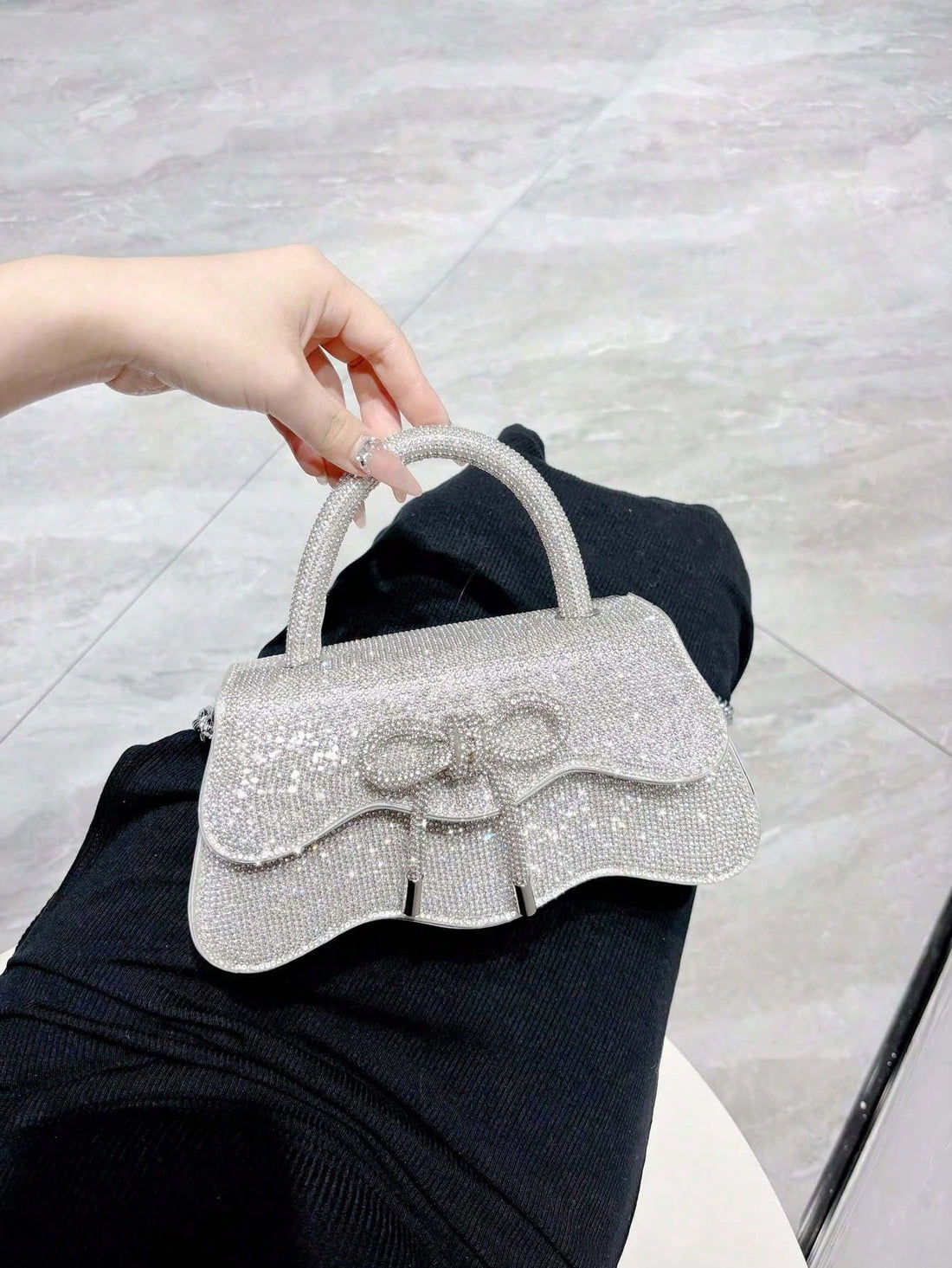 Add sparkle to your night with this dazzling rhinestone evening bag, featuring a chic bow detail for a touch of whimsy. Perfectly sized as a crossbody, it keeps your essentials close while you dance the night away at parties, weddings, or holiday celebrations. Shine bright and let your style do the talking!