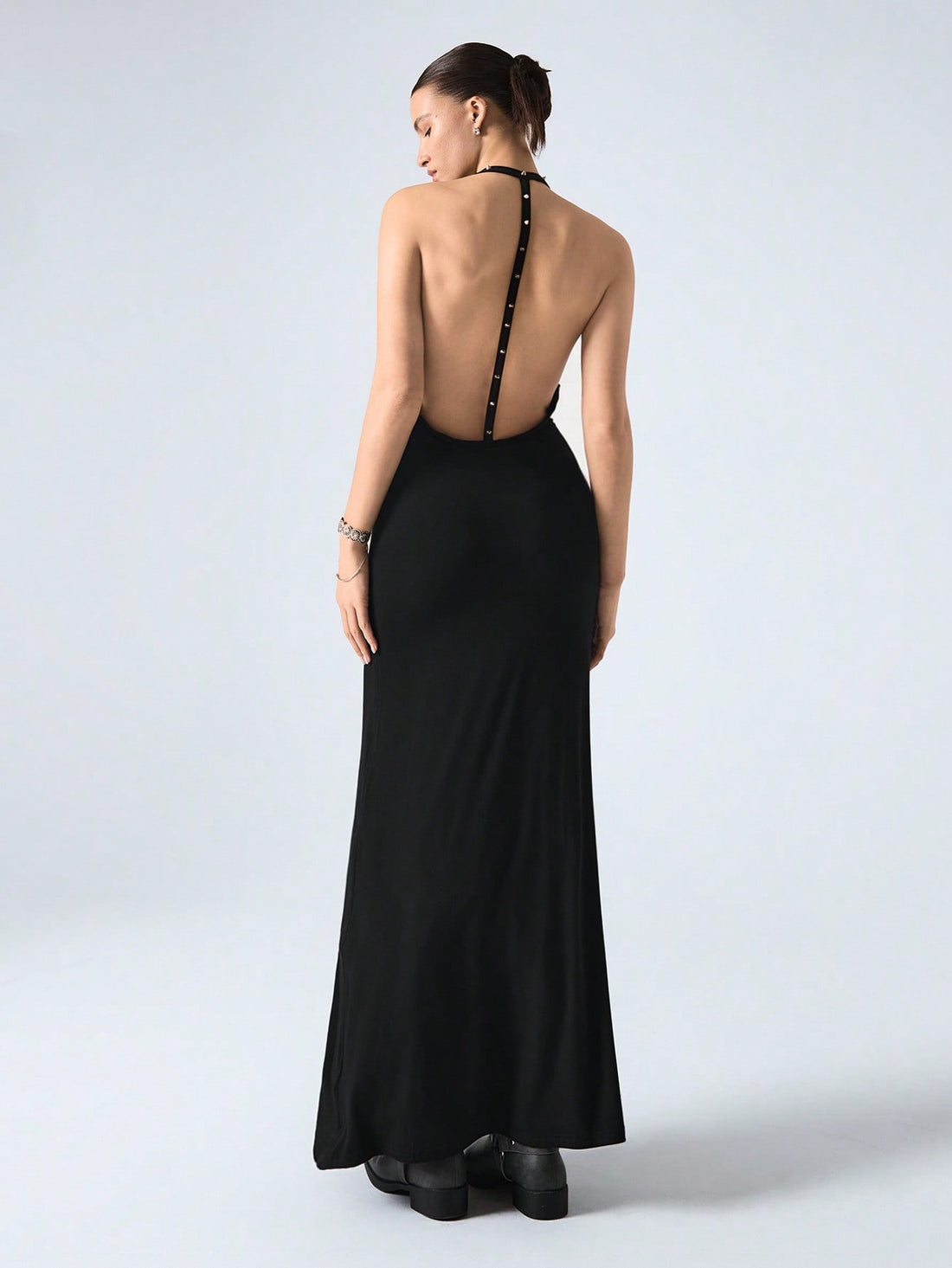 Turn heads in this playful yet elegant maxi dress featuring a chic studded halter neckline and a daring backless design. The mermaid hem adds a flirty flair, perfect for dancing the night away or making a statement at your next special event. Embrace your confidence and let your style shine!