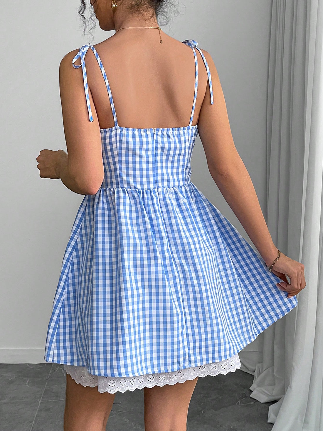 Effortlessly elevate your style with our Chic Plaid Mini Slip Dress. Featuring a trendy plaid print and a playful tie-up detail, this dress adds a touch of quirkiness to any outfit. Perfect for a fun and stylish look, this dress is a must-have for any fashion-forward individual.