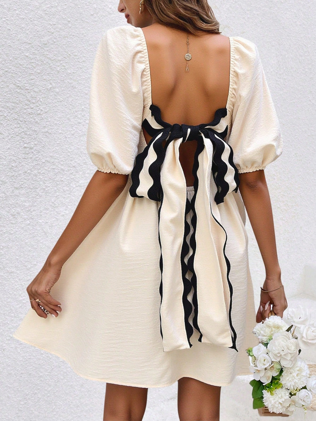 Elevate your summer wardrobe with our Enchanting Frenchy Women's Elegant Puff Sleeve Sundress. The back tie and wavy trim add a touch of whimsy, while the puff sleeves add an elegant touch. Perfect for any occasion, this dress will make you feel stylish and confident.