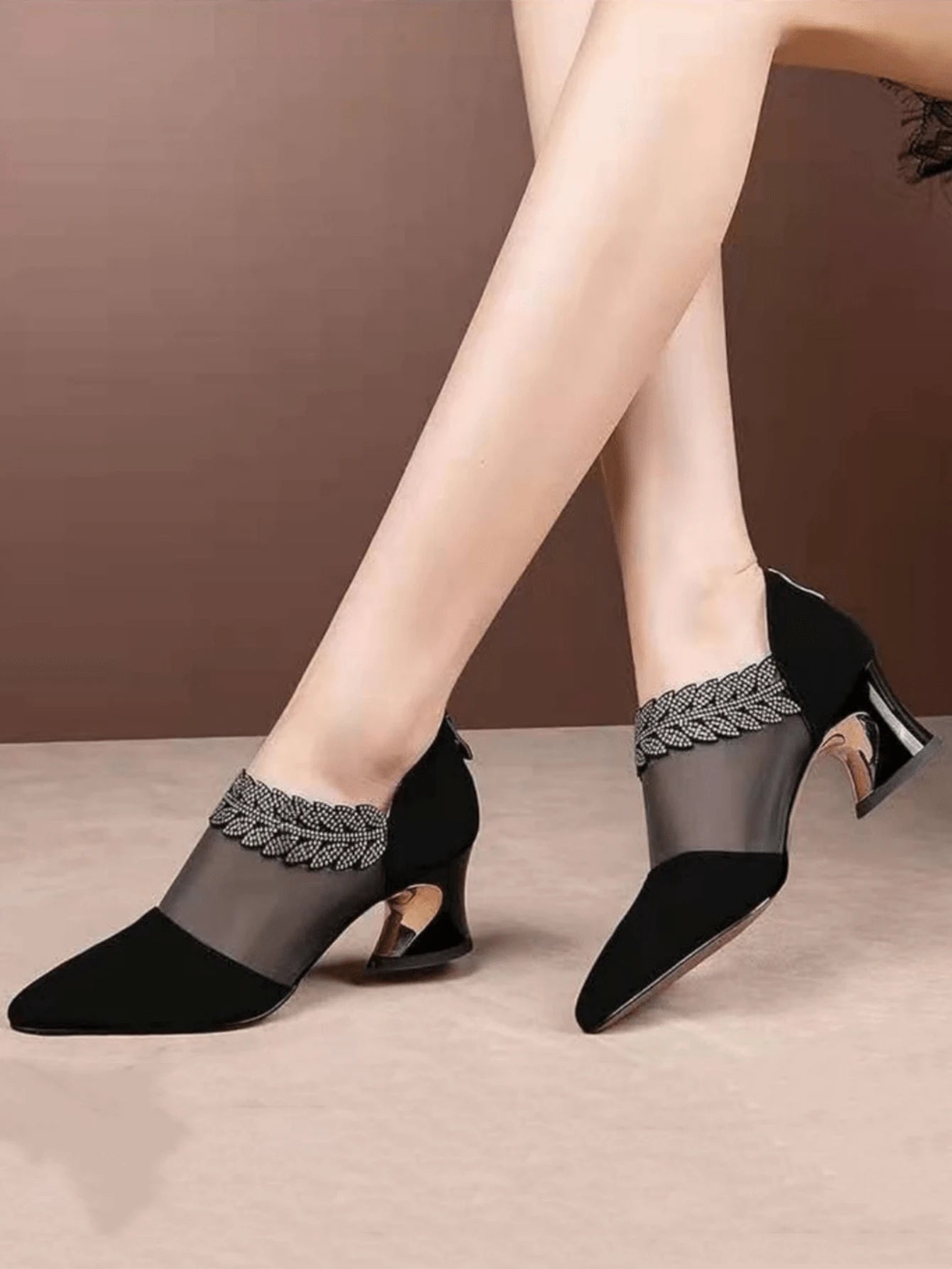 Side view of black rhinestone mesh pumps with low chunky heel and pointed toe
