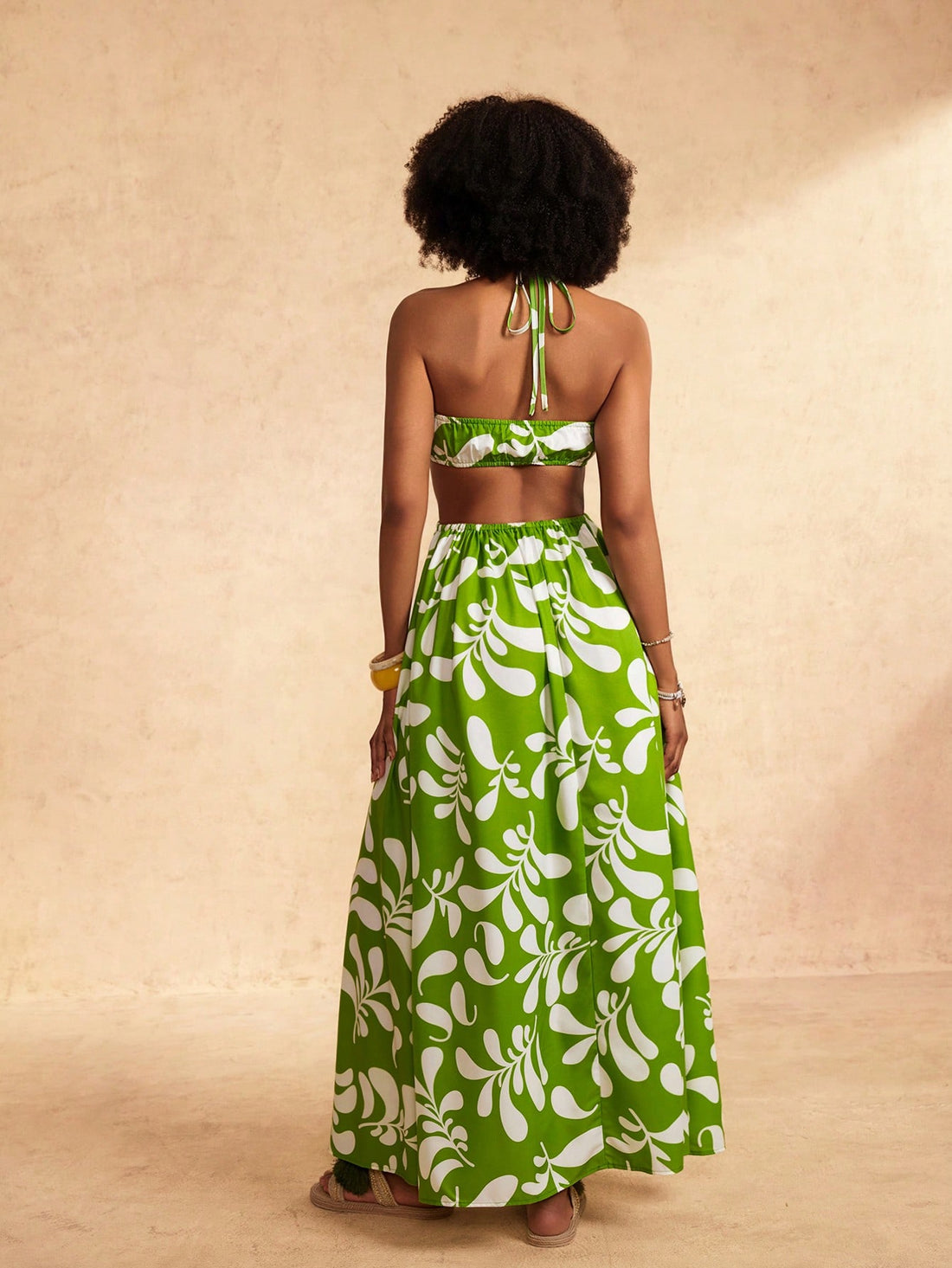 Get ready for effortless Hawaiian vibes with our stylish green plant print halter dress! Perfect for spring and summer vacations, this dress will have you feeling fresh and ready to soak up some sunshine. Embrace the island life in style with this quirky and playful dress.