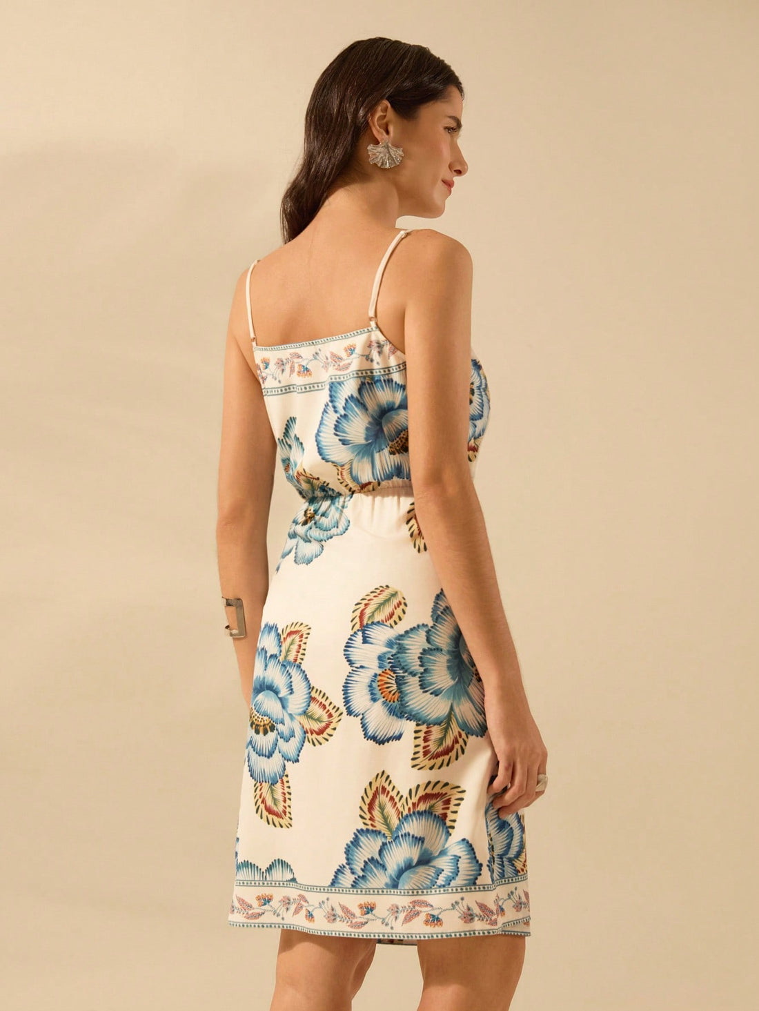 Unleash your inner boho babe in this playful Tropical Floral Strappy Wrap Mini Dress! With its effortless summer style, you'll be turning heads all season long. The flattering wrap design and strappy details add a touch of chic sophistication. Perfect for any occasion, this dress is a must-have for your summer wardrobe!