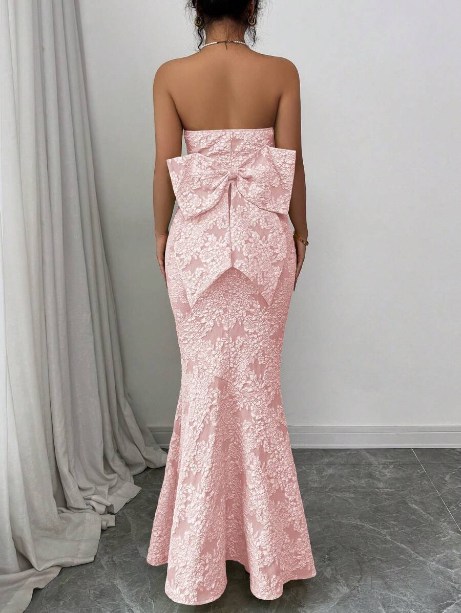 Turn heads at your next special event in this stunning strapless fish tail dress! Featuring intricate floral embossing that catches the light beautifully, paired with a show-stopping butterfly back detail that's pure magic. The elegant silhouette hugs your curves in all the right places, while the dramatic fishtail hem adds that extra touch of glamour and movement. Perfect for galas, weddings, or any occasion where you want to feel absolutely fabulous. This dress isn't just an outfit—it's your moment to shi