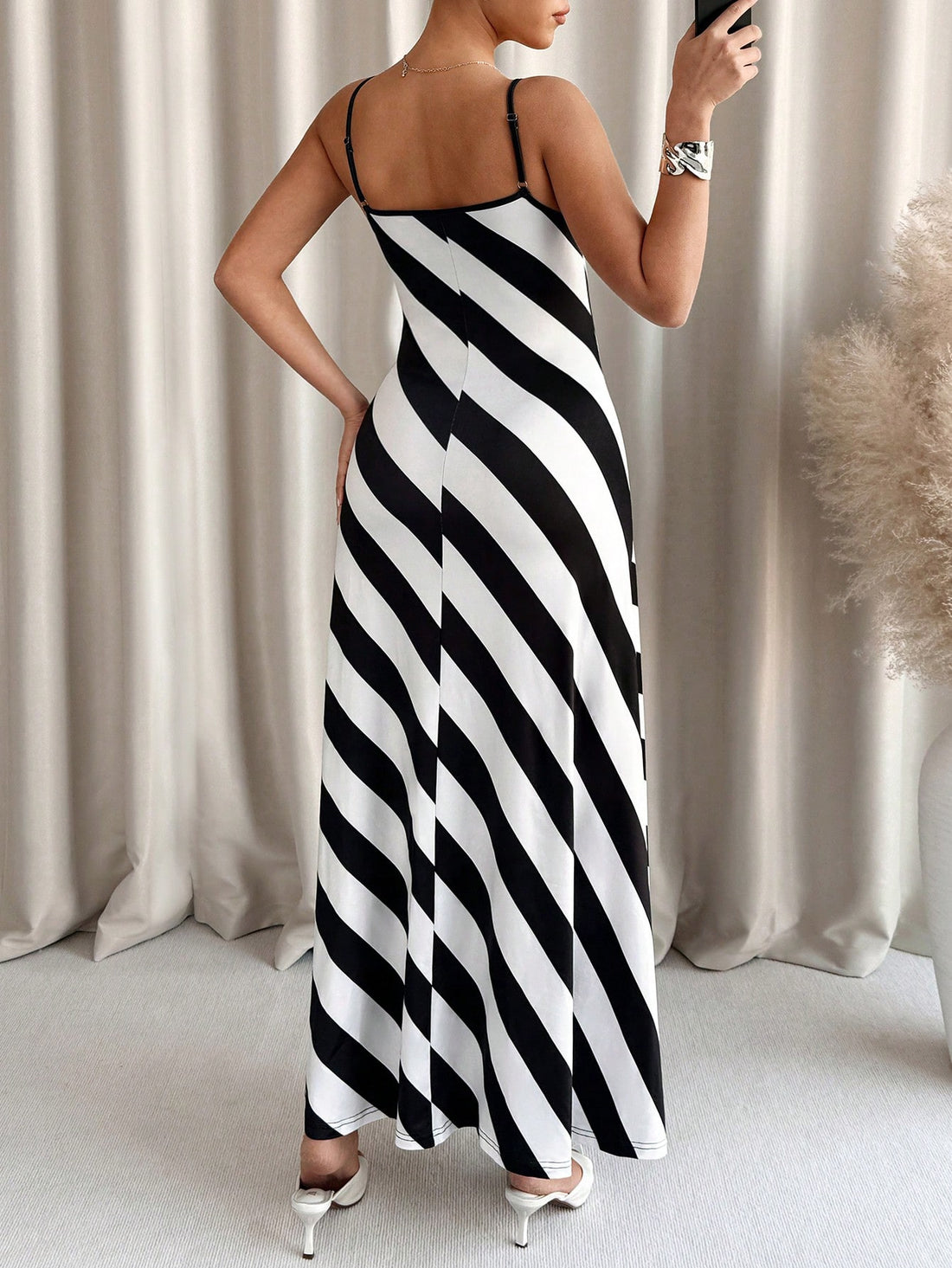 Effortlessly chic! Summer vacation must-have! This striped sleeveless dress is the perfect choice for a carefree and stylish look. Stripes never go out of style! Whether you're strolling on the beach or exploring a new city, this dress will keep you looking cool and confident. Get your vacation on!