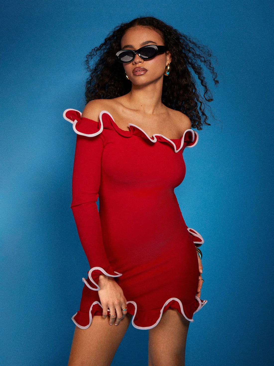 Turn heads in this effortlessly chic off-shoulder mini dress that perfectly balances elegance with edge. The fitted silhouette hugs your curves in all the right ways, while playful ruffle details along the neckline add a flirty touch. Long sleeves keep things sophisticated without sacrificing that show-stopping off-shoulder moment. Whether you're heading to a night out or a special occasion, this dress is your go-to for looking polished and feeling fabulous. Dress it up with heels or keep it casual with sne