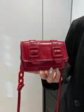 Everyday styling view of mini polyurethane bag with adjustable strap