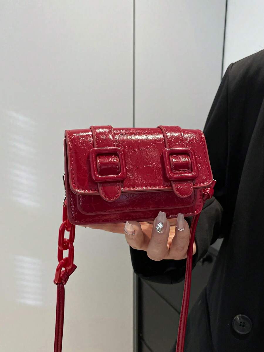Everyday styling view of mini polyurethane bag with adjustable strap
