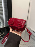 Angled detail of square mini bag with acrylic decoration