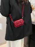 Close-up of chain strap hardware on the mini crossbody bag