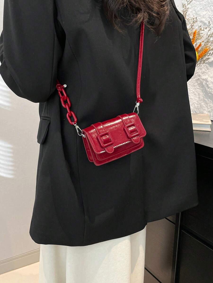 Close-up of chain strap hardware on the mini crossbody bag