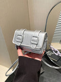 Lifestyle angle of mini preppy crossbody bag with colorful finish