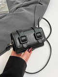 Close-up of color block finish on compact mini crossbody bag