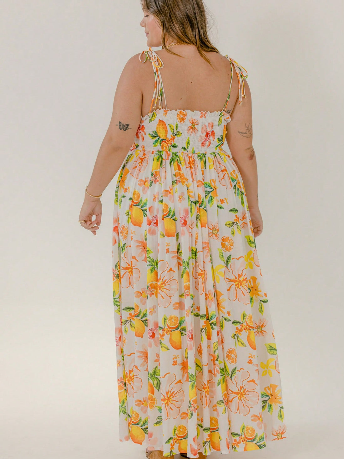 Step into sunshine and ease with the Curve Floral Tie Strap Smocked Maxi Dress. Its playful floral pattern and adjustable tie straps bring flirtatious charm, while the smocked bodice offers comfy stretch that flatters your curves. Perfect for beach strolls or sunset dinners, this maxi dress blends carefree style with vacation-ready vibes.