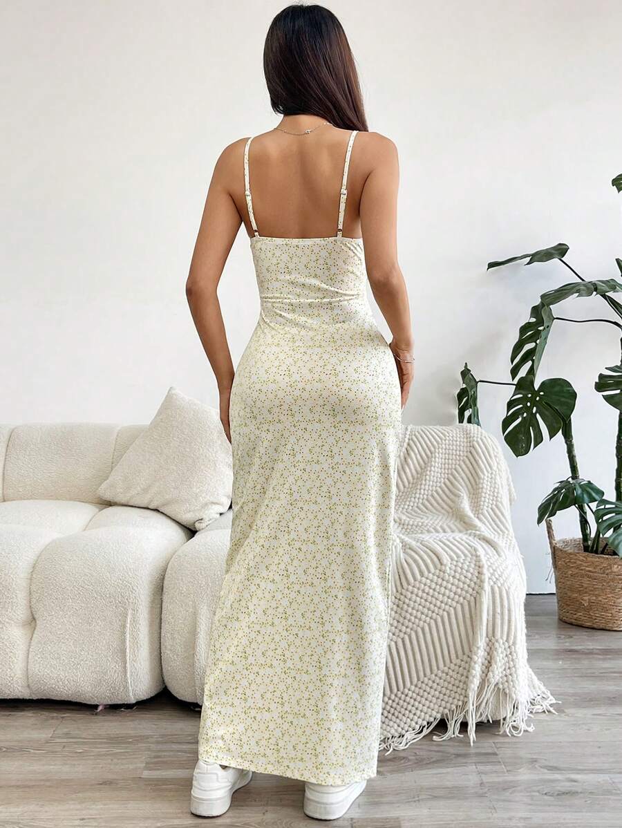 Effortlessly exude elegance in this chic floral camisole dress. Featuring a playful cutout and dramatic thigh slit, this dress is perfect for any occasion. With its unique design, you'll stand out and turn heads wherever you go. Who said elegance has to be boring?