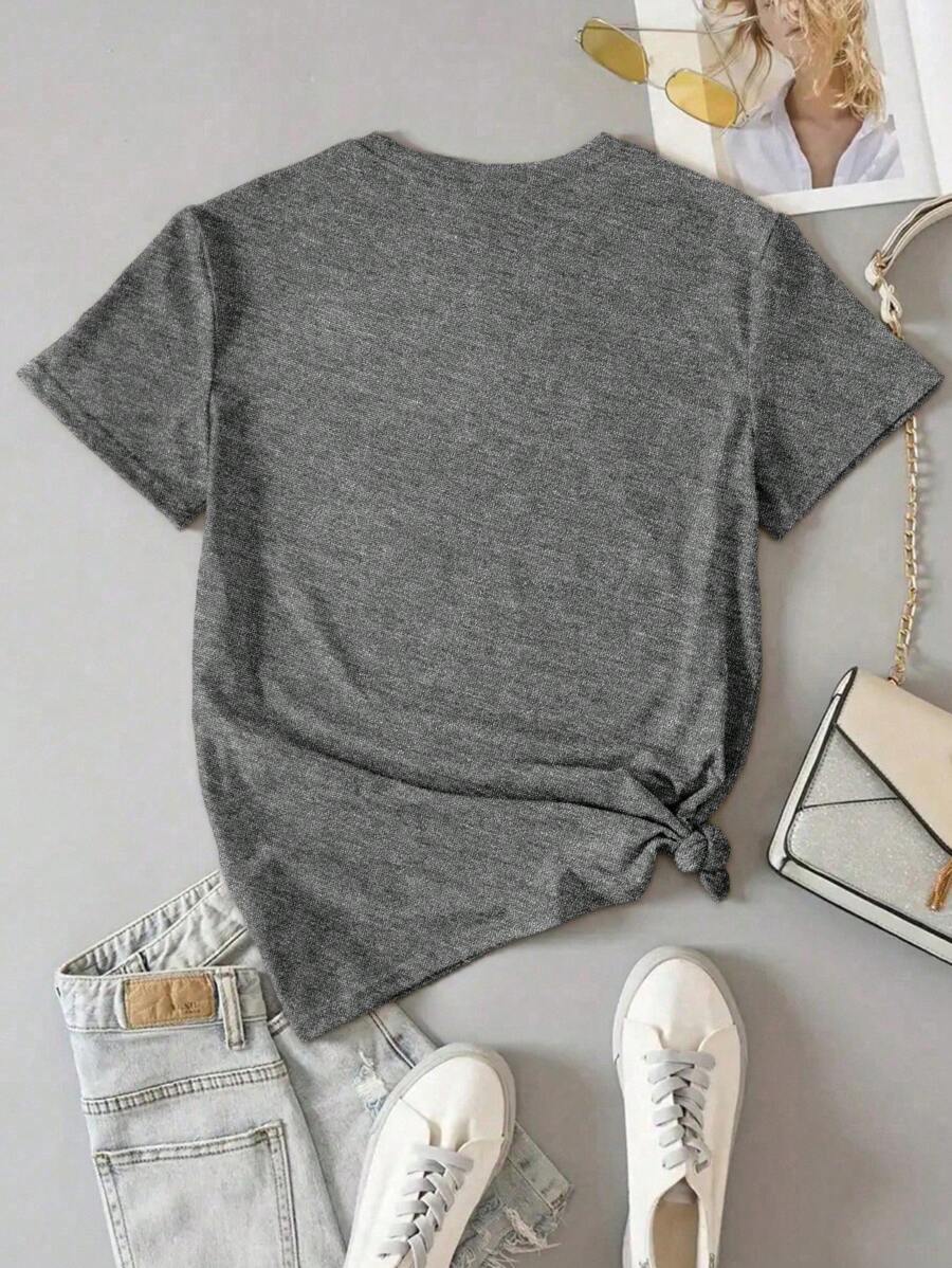 Front model view of washed grey Free Bird eagle graphic T-shirt styled with denim shorts